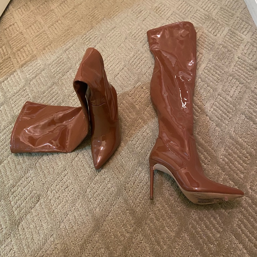 Brown thigh high boots.